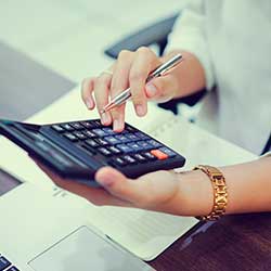 Accountant Woman Hand Press on Calculator while Setting Budget