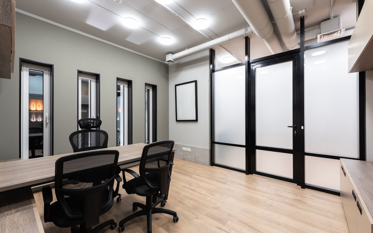 Technician installing a privacy door in a commercial office